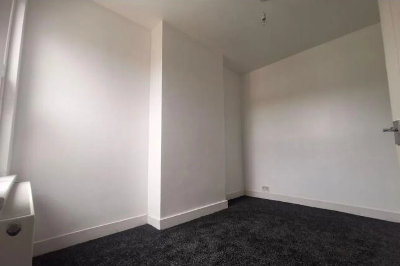 A finished room in the refurbished Bedford terrace, decorated and carpeted after the heating work was completed
