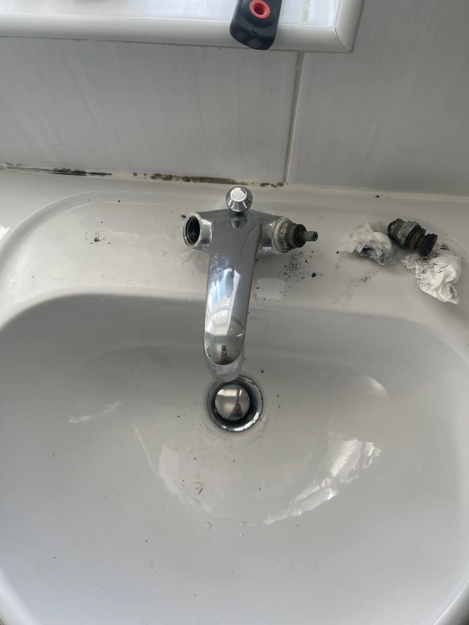 A worn tap valve removed from a dripping basin mixer during a repair.